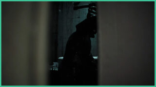 The point of view from someone peeking through a gap to see someone wearing dark clothing, lifting an axe into the air in Dread Neighbour. The point of view from someone peeking through a gap to see someone wearing dark clothing, lifting an axe into the air in Dread Neighbour.
