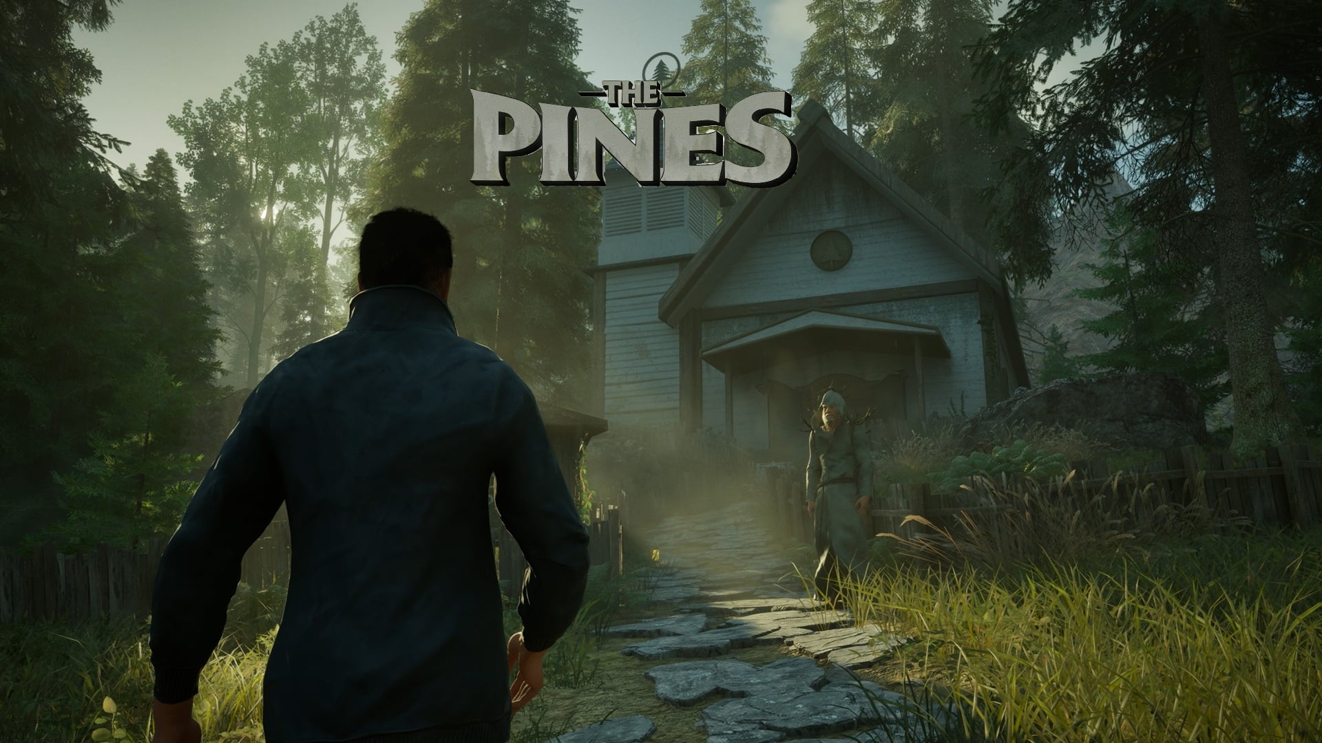 featured image for our news on The Pines. It shows a man in front of a house. There are lots of pine trees adjacent to the house.